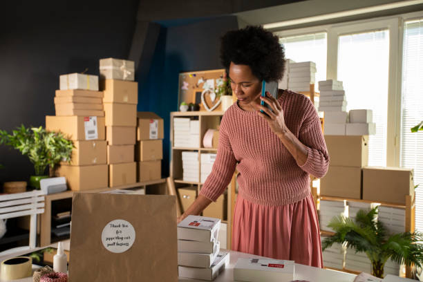 istock Getting packages ready for shipping and calling a delivery service 1301007472