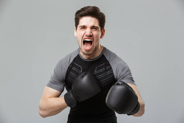 istock Screaming emotional young sportsman boxer 1301007767