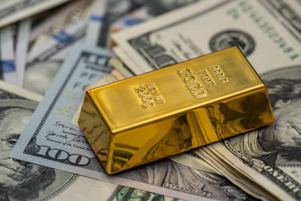 istock finance concept dollar bills and gold bar 1301007831