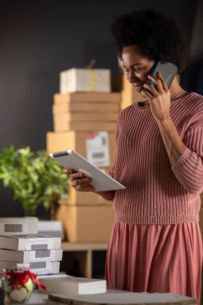 istock Using digital tablet and talking with delivery people over the phone 1301007924