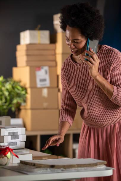 istock Organizing her small business over the phone 1301008218