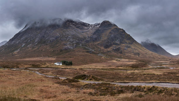 istock Majestic landscape image view down Glencoe Valley in Scottish Highlands with mountain ranges in dramatic Winter lighting 1301009325