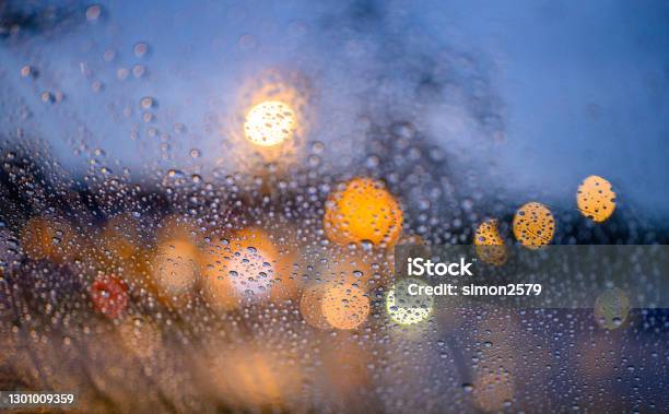 Rain Droplets Cling To The Car Glass At Dusk Stock Photo - Download Image Now - Rain, Defocused, Blurred Motion