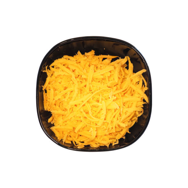 istock Grated cheese in black plate isolated on white background, top view 1301010655