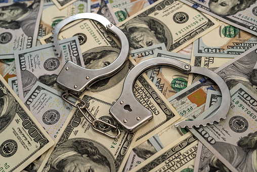 arrest of criminals. metal handcuffs on hundred dollar banknotes