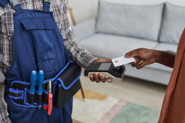 istock Woman Paying for Handyman Services 1301014339