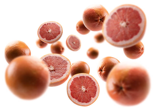 istock Whole and cut grapefruits levitate on a white background 1301017299