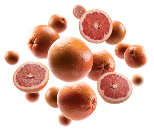 istock Whole and cut grapefruits levitate on a white background 1301017315