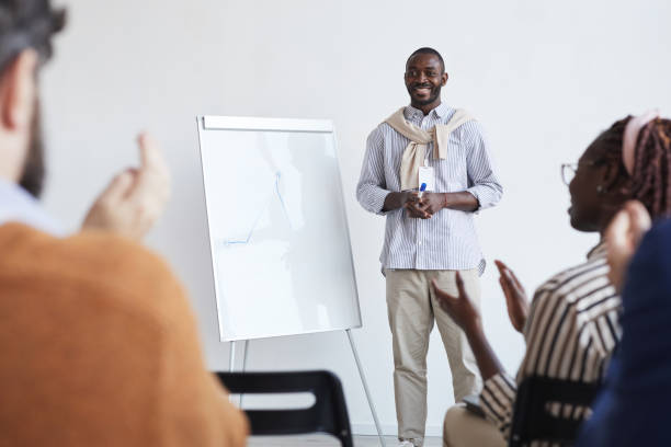 istock Smiling African-American Speaker at Conference 1301017486