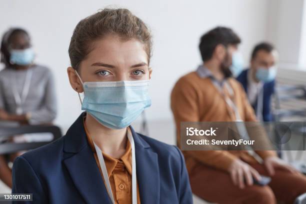Young Woman Wearing Mask In Audience Stock Photo - Download Image Now - Protective Face Mask, Women, Audience