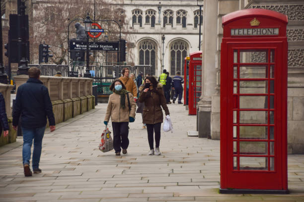 personnes utilisant des masques facaux dans parliament square, londres - pay phone telephone people women photos et images de collection