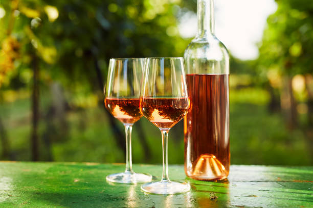 istock Two glasses of rose wine and a bottle 1301017792
