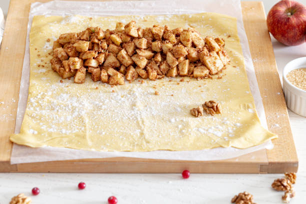 istock making strudel - dough, apples, cinnamon, nuts, brown sugar. woman preparing apple strudel 1301019114