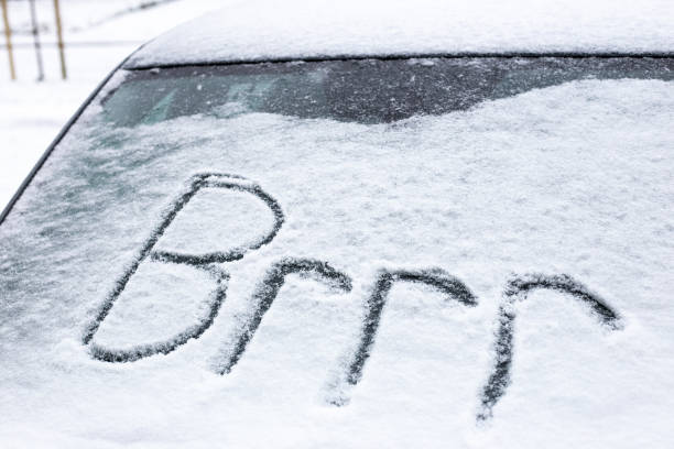 istock Freezing cold car in blizzard with brrr written in the snow 1301019816
