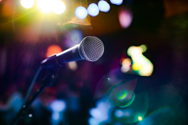 istock Microphone on stage against a background of auditorium. 1301020618