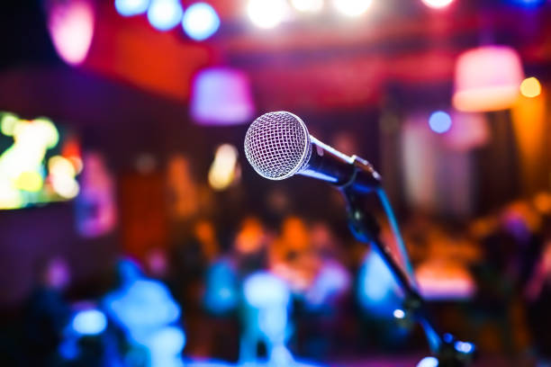 istock Microphone on stage against a background of auditorium. 1301020624