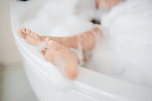 istock Women's feet she is taking a bath in the bath with relaxation. 1301021835