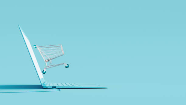 オンラインショッピングコンセプト。青い背景にラップトップとショッピングカート - オンラインショッピング ストックフォトと画像