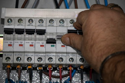Connecting wires to the underfloor heating controller. Electric installation work.