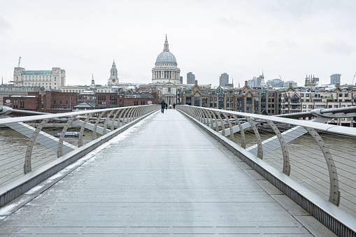 08 February 2021. As storm Darcy rages on, London wakes up covered in snow. Millennium Bridge, St Paul Cathedral.