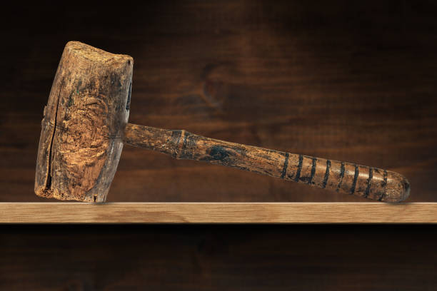istock Old Wooden Mallet or Hammer on a Shelf 1301028912
