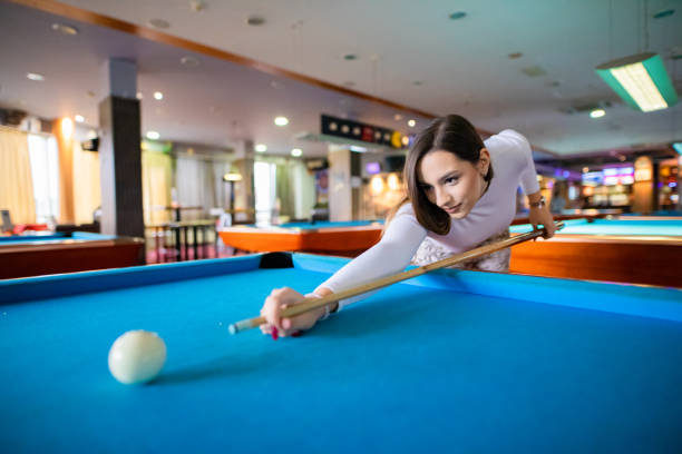 Beautiful girl playing pool stock photo