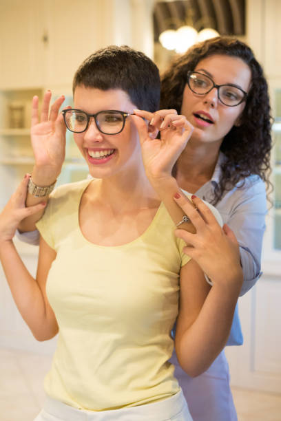 istock Women trying on eyeglasses in optical shop 1301031228