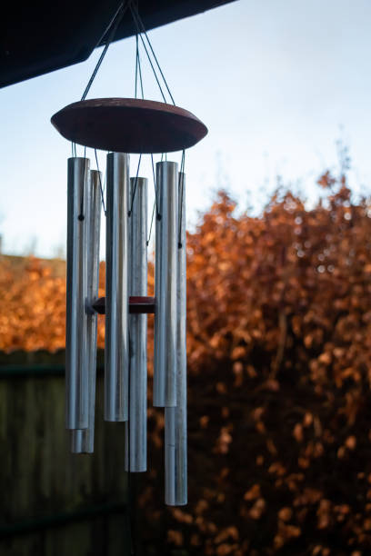 istock Metal wind chimes decor hanging in a garden with autumn or fall colours 1301032146