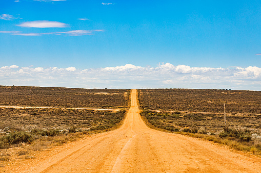 Straight orange dirt road in outback Australia