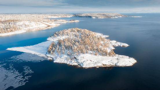 National Park Ladoga Skerries, in winter in Karelia Russia Small  stone islands in the snow on Lake Ladoga  on a sunny day