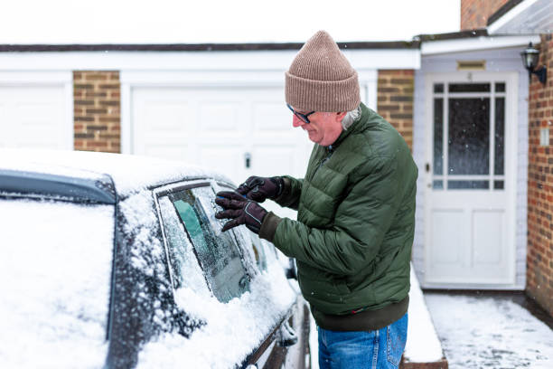 istock Adult man de-icing snow covered car in winter 1301035954