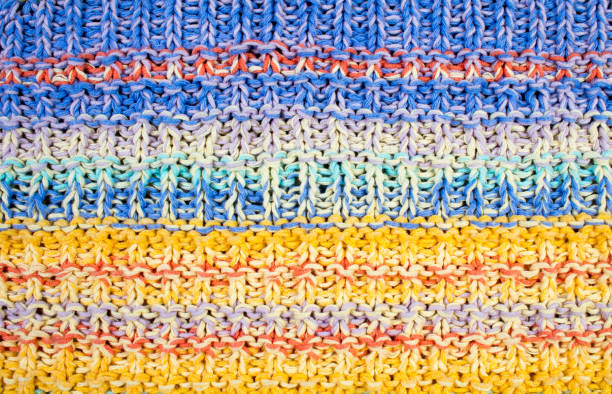 istock Sweater or scarf fabric texture large knitting. Knitted jersey background with a relief pattern. Wool hand- machine, handmade. 1301036239