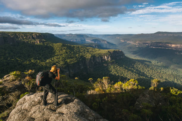 istock Man photographing mountains and dramatic landscape in Australia 1301036250