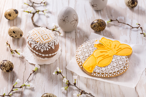 Easter decoration with homemade Easter gingerbread cookies on wooden table