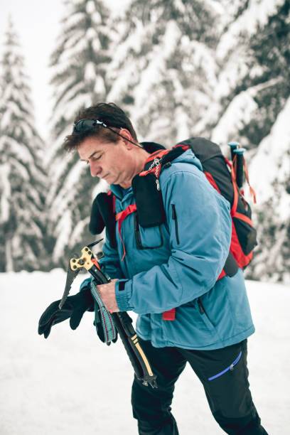 istock Senior Male Ready To Head Out Through Mountain Snow While Hiking 1301037352