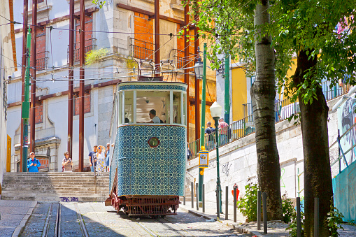 Lisbon, Portugal - June 13, 2013: Carriage of Gloria Funicular decorated with Azulejos tiles in Pombaline downtown of Portuguese capital Lisbon