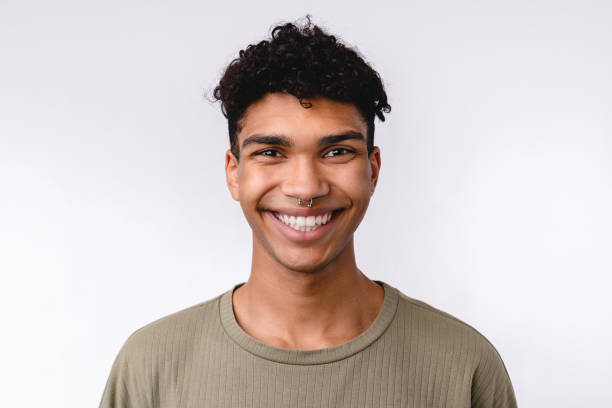 istock Good-looking young mixed-race man in casual clothes smiling with teeth isolated over white background 1301037555