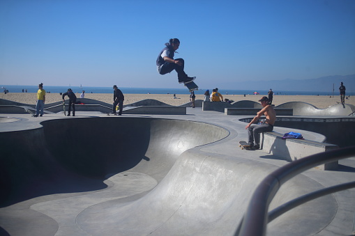 For Editorial Use:Venice Beach, CA, February 6, 2021: Skateboarder catches some air.