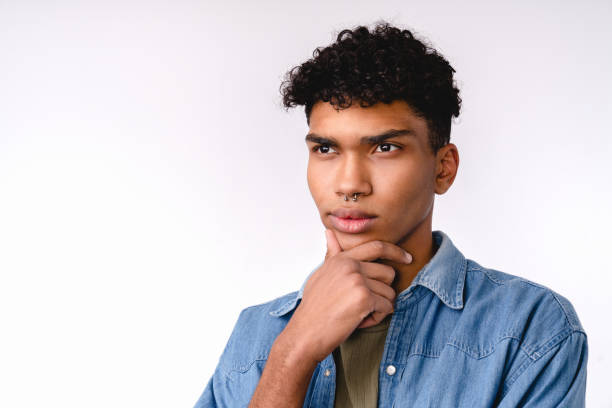 istock Thoughtful young african man in casual clothes isolated over white background 1301037659