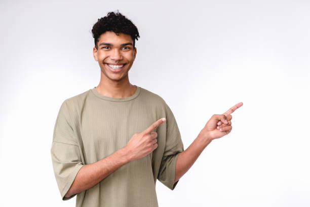 istock Young mixed-race man pointing at copy space isolated over white background 1301037835