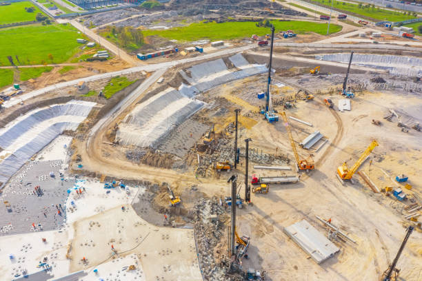 istock Equipment for installing piles in ground, heavy machines for driving pillars work in laying the foundation building. Construction aerial view height. 1301038423