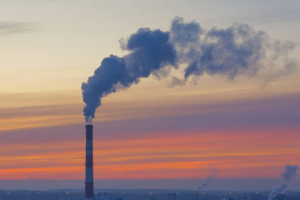 istock Lonely chimney with smoke and carbon dioxide emissions from fuel combustion. 1301038553