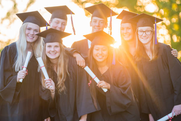 istock Group of happy high school graduates 1301038771