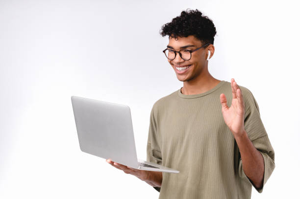 istock Happy afro male student having video call on laptop isolated over white background 1301038923