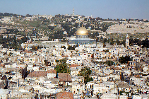 The Dome of the Rock is an Islamic shrine located on the Temple Mount in the Old City of Jerusalem. This view was taken from the tower of the Lutheran church with the mount of olives in the background
