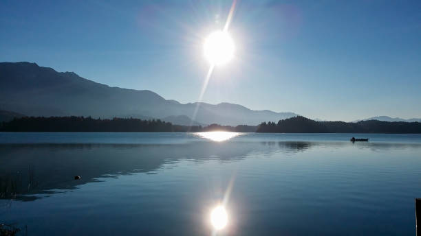 istock Faakersee - A panoramic view on the Faaker lake in Austrian Alps. The lake is surrounded by high mountains. Calm surface 1301039985