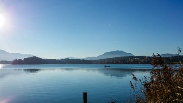 istock Faakersee - A panoramic view on the Faaker lake in Austrian Alps. The lake is surrounded by high mountains. Calm surface 1301039986