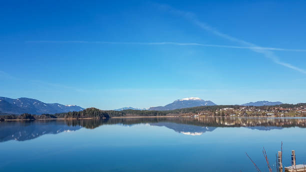 istock Faakersee - A panoramic view on the Faaker lake in Austrian Alps. The lake is surrounded by high mountains. Calm surface 1301040146