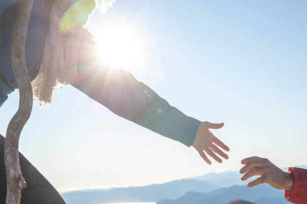istock Mature couple hike up sunny mountain ridge 1301040321
