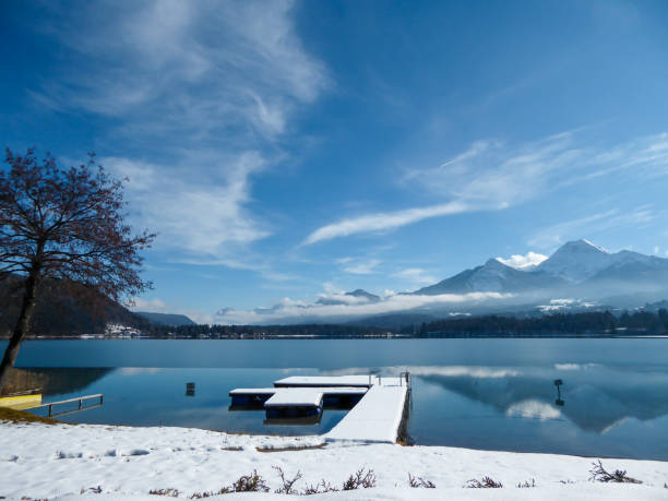 istock Faakersee - A panoramic view on the Faaker lake in Austrian Alps. The lake is surrounded by high mountains. 1301040332